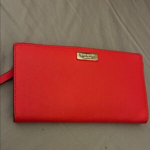 kate spade red zip-around wristlet wallet with gold logo